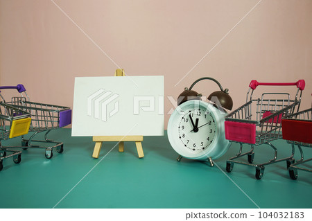 Card mockup space for copy text message on easel standing with alarm clock on pink and blue background Card mockup space for copy text message on easel standing with alarm clock on pink and blue background 104032183