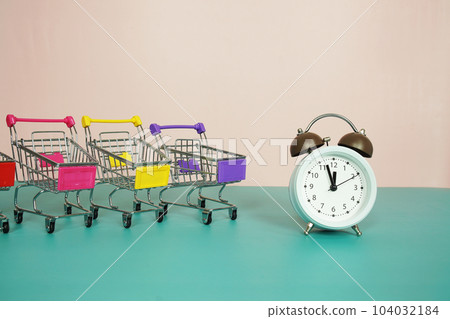 Alarm clock with trolley shopping cart,  Business concept, Shopping concept, purchasing time bacground 104032184