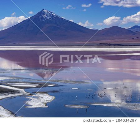 Scene of salt lagoon reflecting mountains and clouds as if in a mirror Scene of salt lagoon reflecting mountains and clouds as if in a mirror 104034297