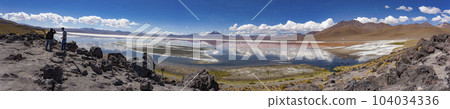 Scene of salt lagoon reflecting mountains and clouds as if in a mirror Scene of salt lagoon reflecting mountains and clouds as if in a mirror 104034336