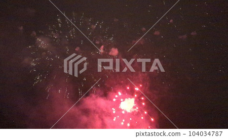 Fireworks blooming in the night sky in midsummer 104034787