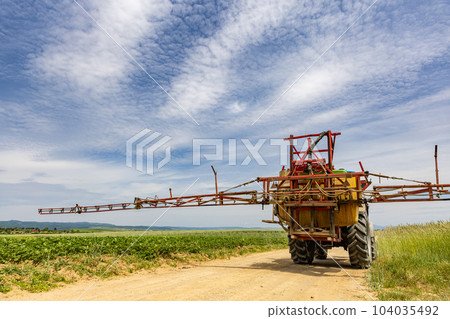 Tractor on agricultural field Tractor on agricultural field 104035492