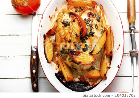 Roasted or grilled chicken breast with persimmon. 104035702