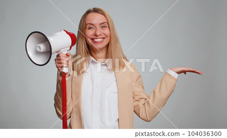Woman talking with megaphone, proclaiming news, loudly announcing advertisement pointing empty place 104036300