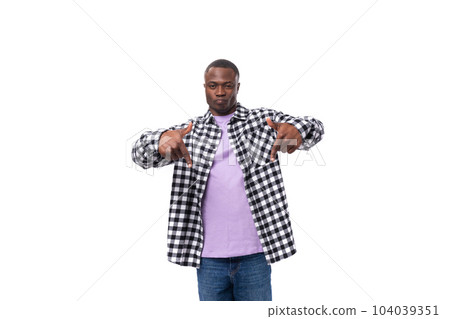 handsome young american man in a plaid shirt shows his hand at the promotional offer on the wall 104039351