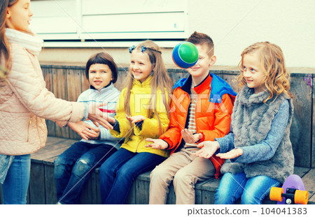 children playing with Ball on bench 104041383