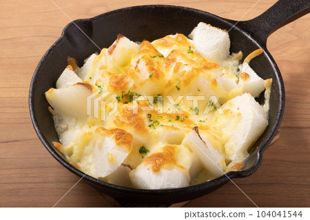 Grilled long potatoes with cheese Grilled long potatoes with cheese 104041544