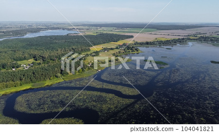 aerial view of Khrinnyky water reservoir, lake or swamp, with field and forest 104041821