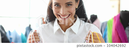 Satisfied happy woman with bright shopping bags buys packages and enjoys discounts 104042692