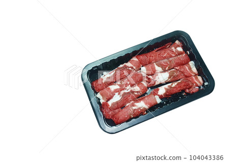 raw frozen beef meat slice roll ingredient food on plastic tray in white background raw frozen beef meat slice roll ingredient food on plastic tray in white background 104043386