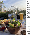 Salad and fries potato chips  104044082