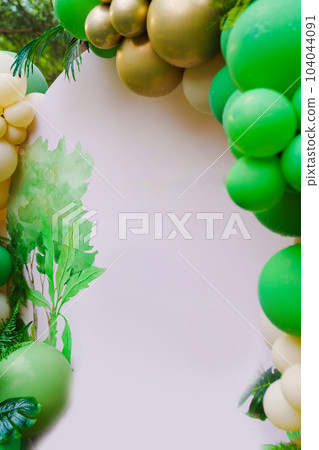 Photo zone in the park at a birthday party - green balloons form an arch Photo zone in the park at a birthday party - green balloons form an arch 104044091