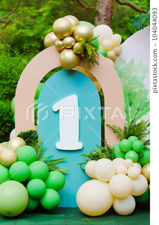 Photo zone in the park at a birthday party - green balloons with the number 1. Photo zone in the park at a birthday party - green balloons with the number 1. 104044093