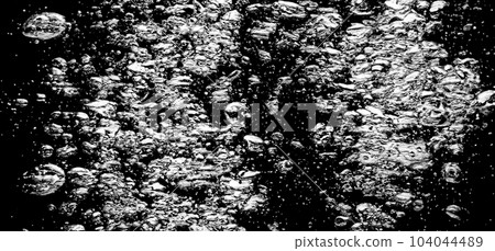 Soda water bubbles splashing underwater against black background. Cola liquid texture that fizzing and floating up to surface like a explosion in under water for refreshing carbonate drink concept. Soda water bubbles splashing underwater against black background. Cola liquid texture that fizzing and floating up to surface like a explosion in under water for refreshing carbonate drink concept. 104044489
