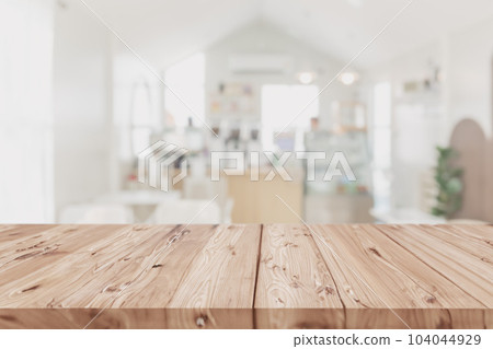Wood table on blur coffee shop background clean bright light foreground Mock up for montage products display 104044929