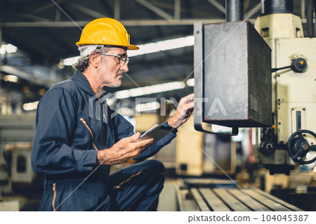 Senior elderly engineer worker high skill operate automate CNC lathe machine in automation factory. Senior elderly engineer worker high skill operate automate CNC lathe machine in automation factory. 104045387