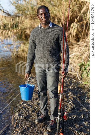 Man returning from fishing Man returning from fishing 104045769