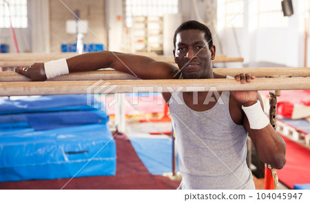 Man training on parallel bars Man training on parallel bars 104045947
