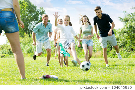Parents with children playing football on outdoor Parents with children playing football on outdoor 104045950