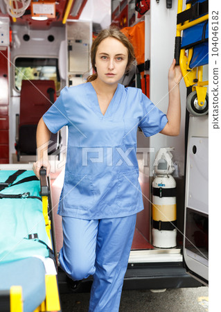Female doctor standing in ambulance auto 104046182