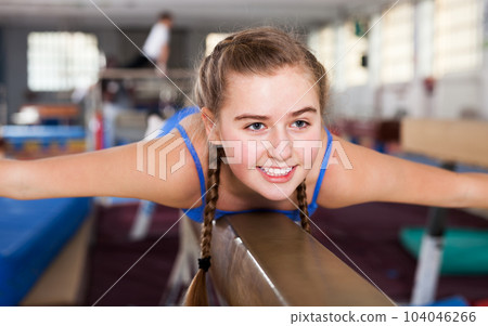 Teenage girl training gymnastics 104046266