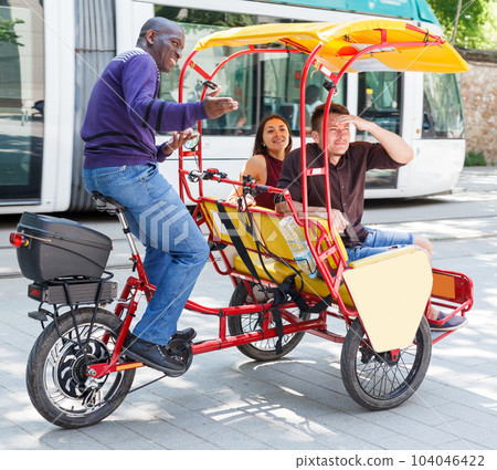 Active tourist couple planning to hire velotaxi Active tourist couple planning to hire velotaxi 104046422