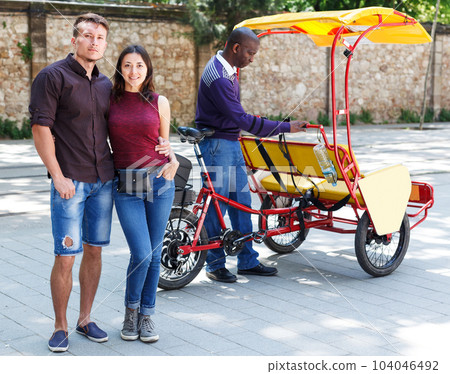Couple near modern rickshaw 104046492
