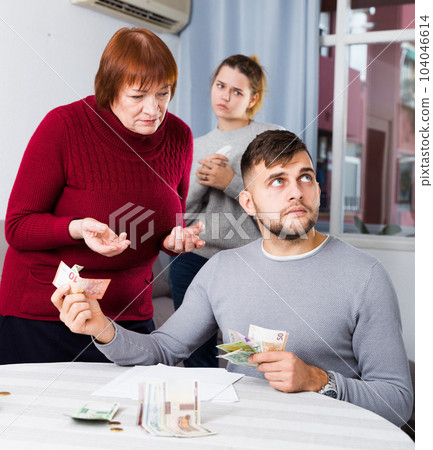 Elderly mother asking adult son for money 104046614