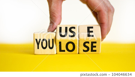 You use or lose it symbol. Concept words You use and You lose on wooden cubes. Businessman hand. Beautiful yellow table white background. Business and you use or lose it concept. Copy space. You use or lose it symbol. Concept words You use and You lose on wooden cubes. Businessman hand. Beautiful yellow table white background. Business and you use or lose it concept. Copy space. 104046634
