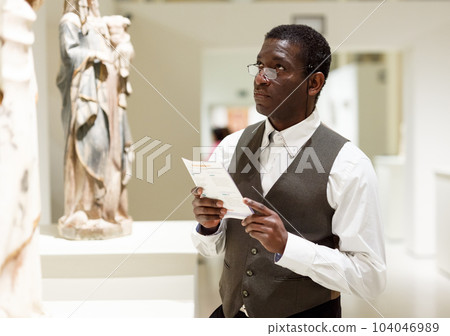Man reading guidebook 104046989