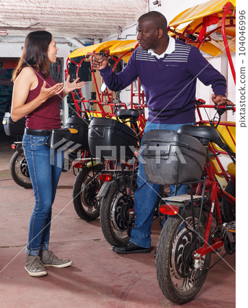 Indignant woman talking to rickshaw driver Indignant woman talking to rickshaw driver 104046996