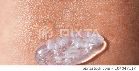 Collagen And Hyaluron Serum Gel On Skin. Splashing of Hyaluron gel. Liquid hyaluronic acid gel on skin. Cosmetic water gel texture on human skin background. Textured background. skin care product. Collagen And Hyaluron Serum Gel On Skin. Splashing of Hyaluron gel. Liquid hyaluronic acid gel on skin. Cosmetic water gel texture on human skin background. Textured background. skin care product. 104047117