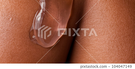 Collagen And Hyaluron Serum Gel On Skin. Splashing of Hyaluron gel. Liquid hyaluronic acid gel on skin. Cosmetic water gel texture on human skin background. Textured background. skin care product. Collagen And Hyaluron Serum Gel On Skin. Splashing of Hyaluron gel. Liquid hyaluronic acid gel on skin. Cosmetic water gel texture on human skin background. Textured background. skin care product. 104047149