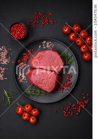 Raw beef eye steak round with salt, spices and herbs Raw beef eye steak round with salt, spices and herbs 104047636