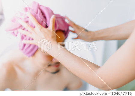 Happy childish disable man being take care of showering by his wife. 104047716