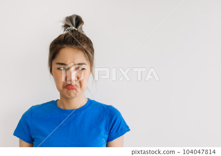 Unsatisfied grumpy woman isolated on white. 104047814