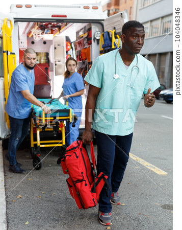 Emergency doctors with first aid kit Emergency doctors with first aid kit 104048346