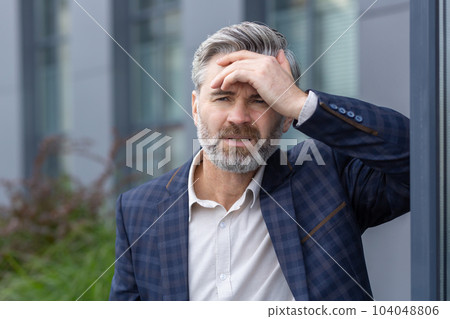 Upset and depressed boss outside office building, financial failure and bankruptcy of mature adult investor, gray haired man in business suit disappointed fails in financing. Upset and depressed boss outside office building, financial failure and bankruptcy of mature adult investor, gray haired man in business suit disappointed fails in financing. 104048806