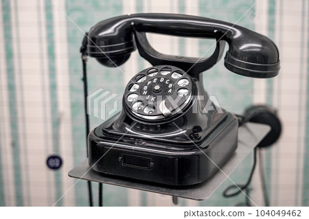 Retro corded rotary telephone in an old room. Retro corded rotary telephone in an old room. 104049462