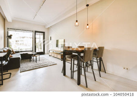 a living room with couches, chairs and a table in front of a sliding glass door that leads to the patio 104050418