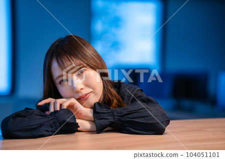 Young woman relaxing in the office after work Young woman relaxing in the office after work 104051101