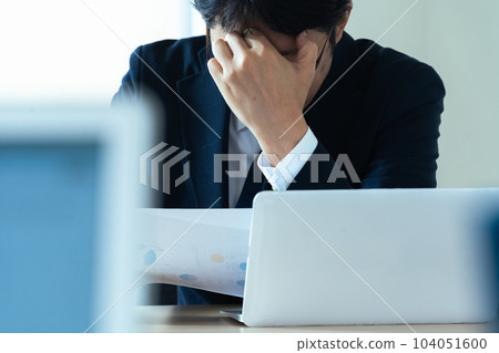 Businessman holding his head Businessman holding his head 104051600