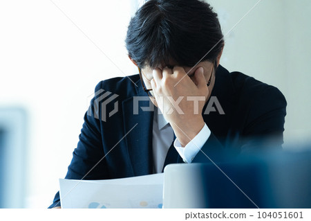 Businessman holding his head Businessman holding his head 104051601