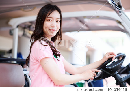 Women playing golf 104054416