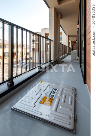 A hatch type rescue bag installed on the balcony of an apartment building 104056359