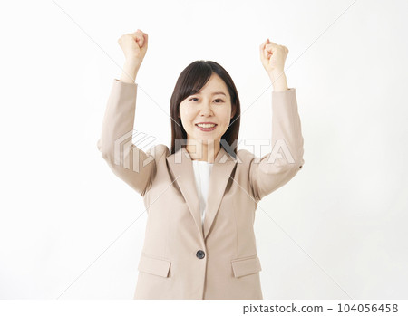 Middle-aged business woman doing a guts pose White background Middle-aged business woman doing a guts pose White background 104056458