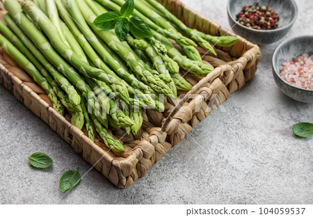 Bunch of raw asparagus stems with different spices Bunch of raw asparagus stems with different spices 104059537
