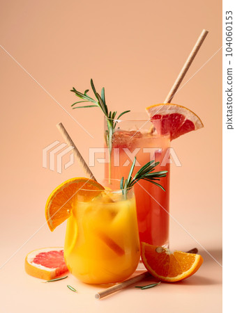 Cocktails with grapefruit, orange, rosemary, and ice. 104060153