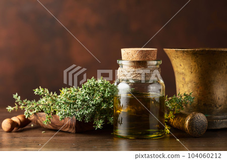 Bottle of thyme essential oil with fresh thyme. 104060212