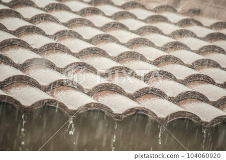 rain falling down from the house roof rain falling down from the house roof 104060920